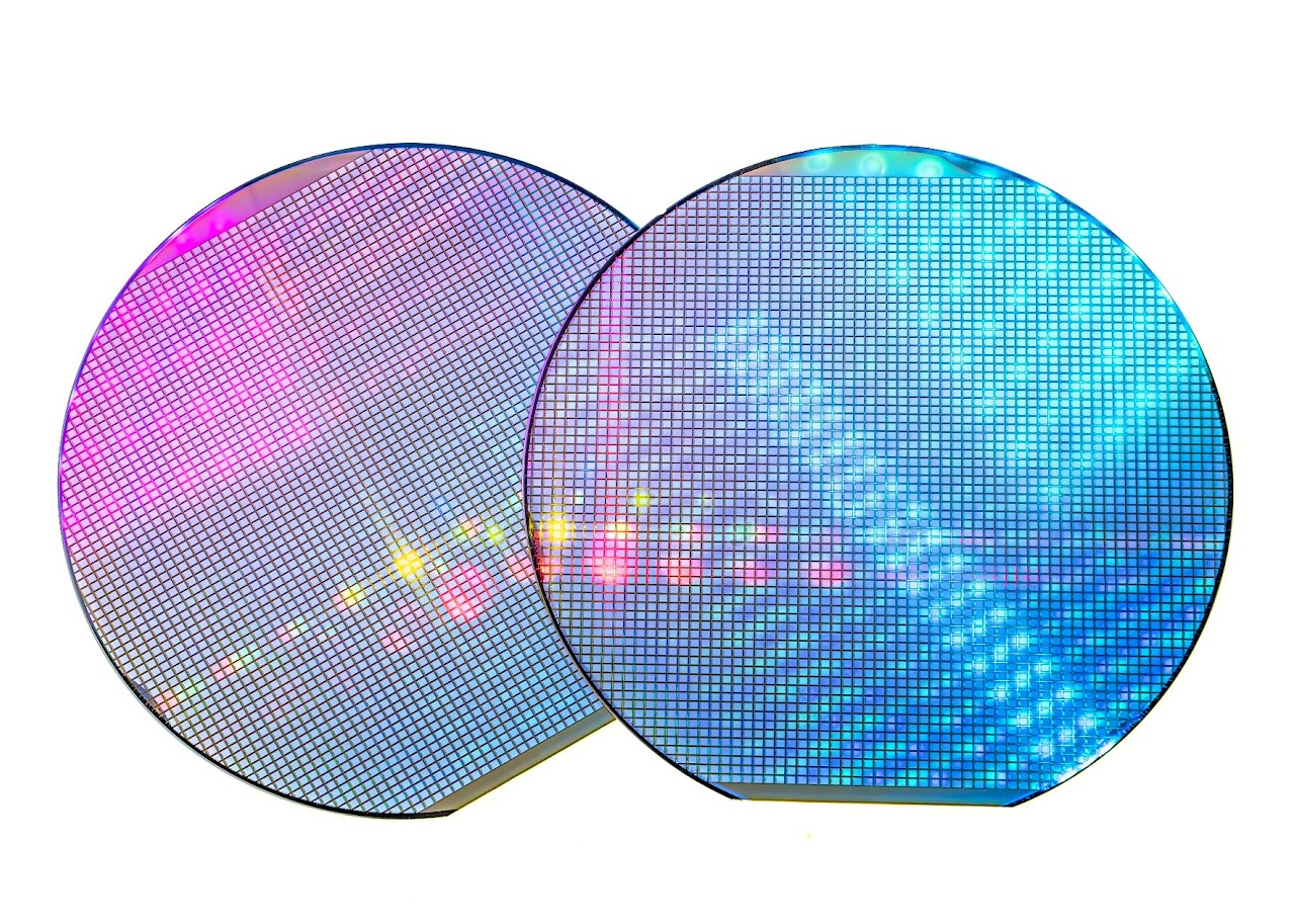 Two iridescent semiconductor wafers showing colorful diffraction patterns — the type of wafer Semi-Bond carriers are designed to handle