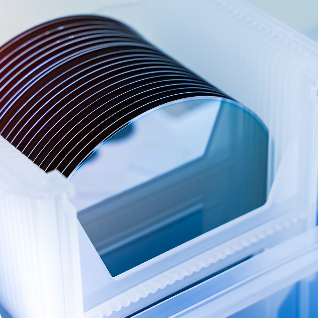 Stack of thin semiconductor wafers held in a carrier cassette — Semi-Bond carriers securely hold wafers through demanding process steps without bond degradation